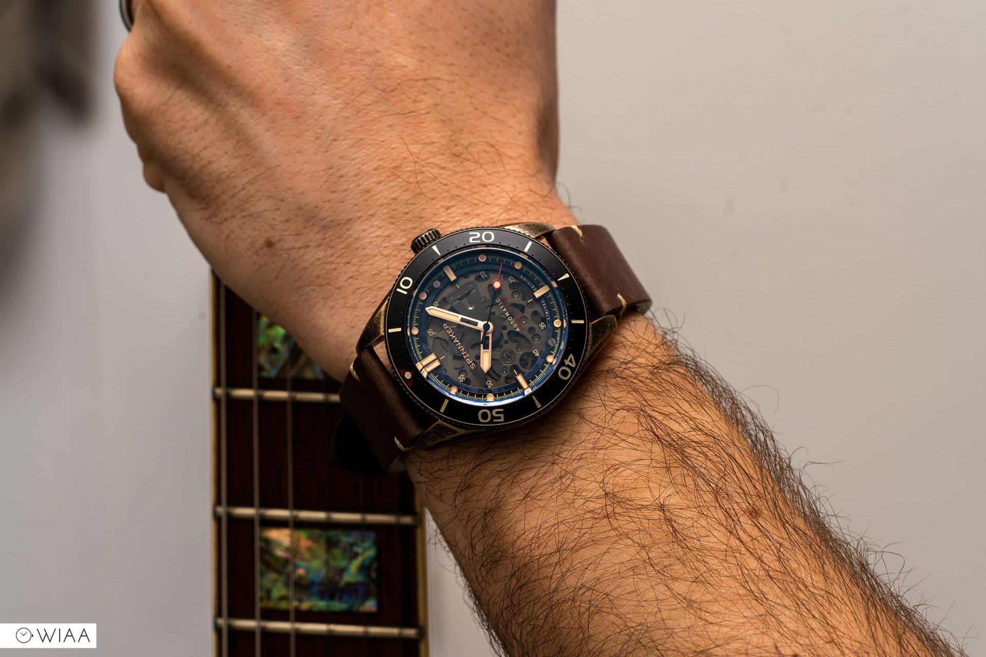 Spinnaker Croft Midsize Limited Edition Watch holding a guitar